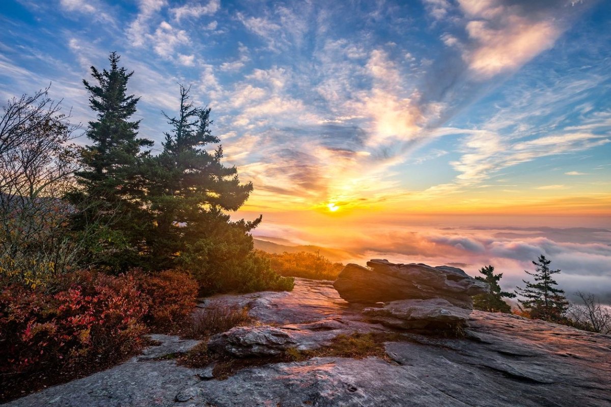 Scenic sunrise over fog filled valley